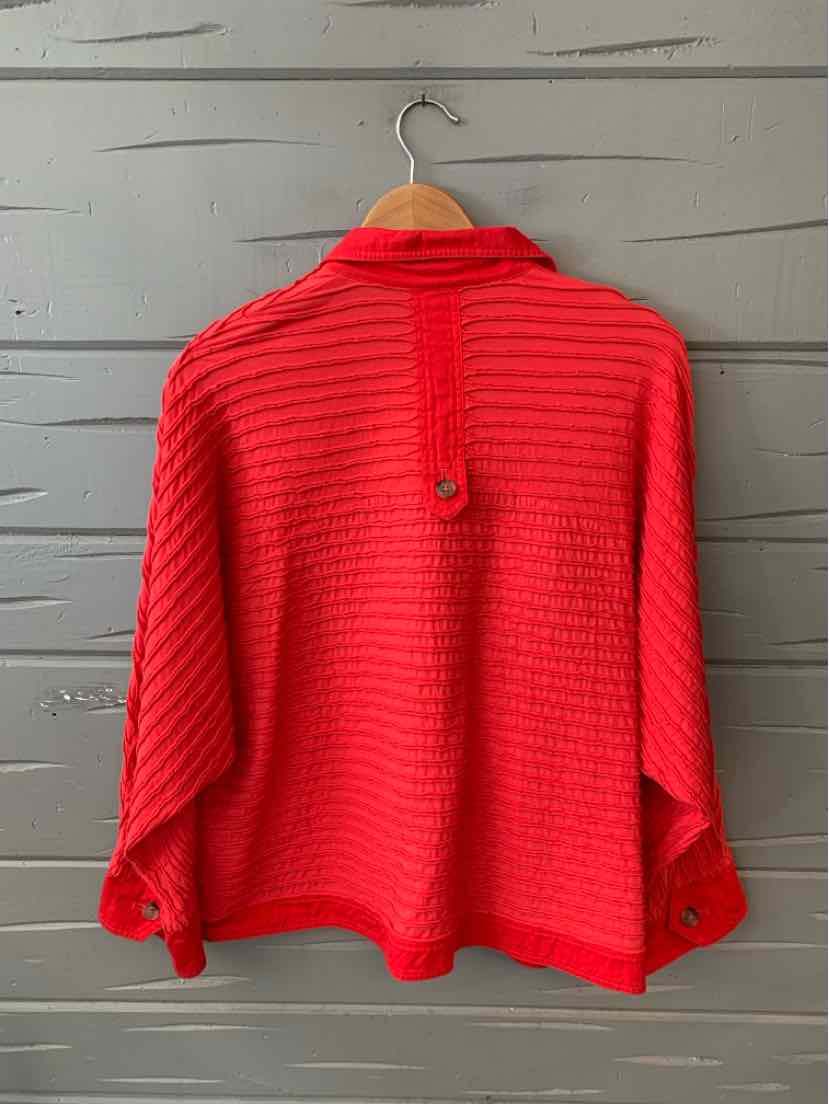Bright red textured knit cardigan with buttoned cuffs and a back loop detail.
