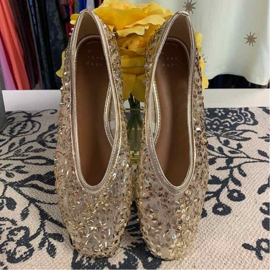 Gold metallic round-toe flats adorned with glittery sequins and beads, size 8.