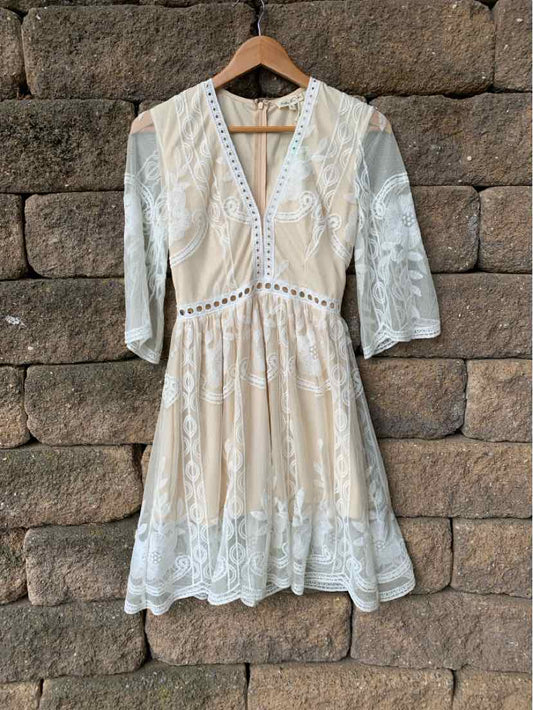 Ivory lace dress with three-quarter sleeves, V-neckline, and scalloped hem, size small.