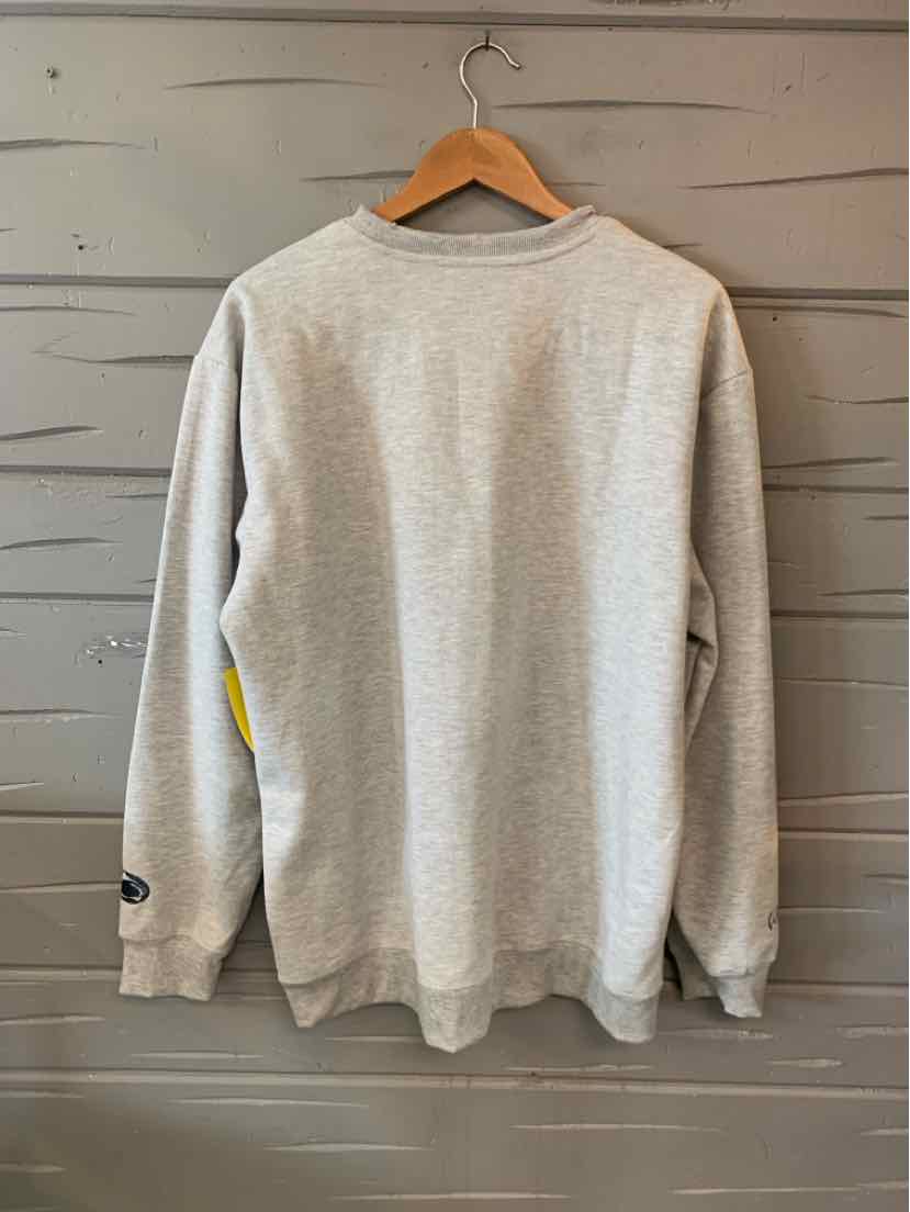 Light gray crewneck sweatshirt with ribbed cuffs and hem, hanging on wooden hanger against gray wooden wall.