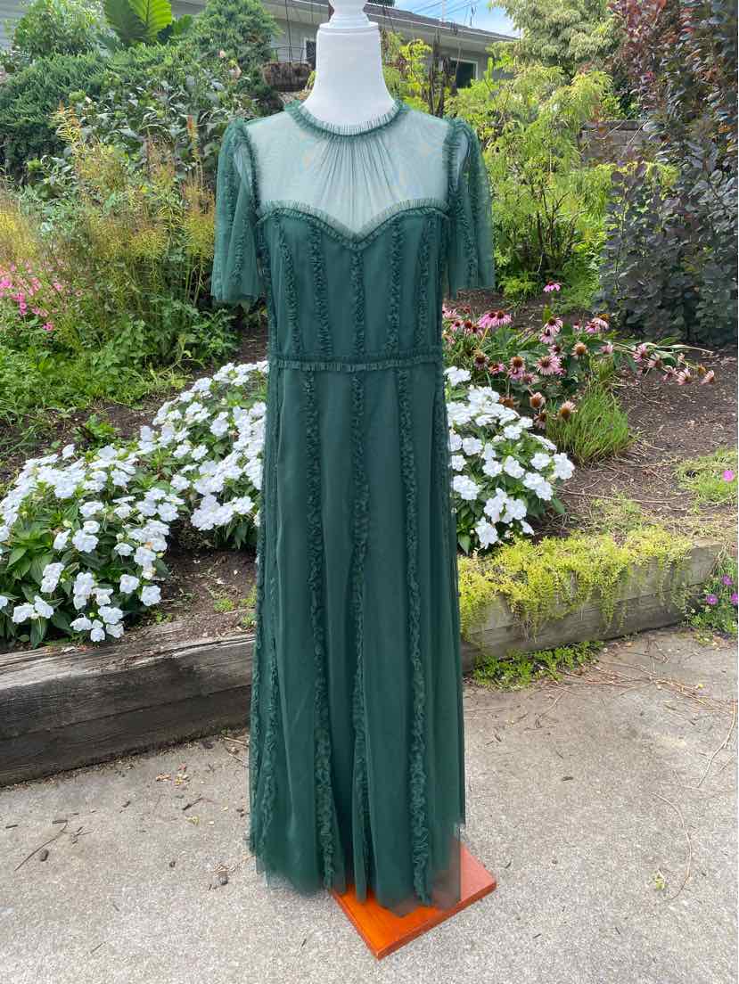 Dark green lace maxi dress with sheer puff sleeves and fitted waist on a mannequin outdoors.