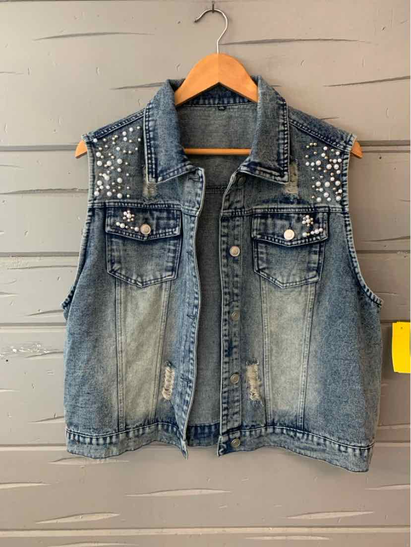 Sleeveless denim vest in faded blue with silver stud detailing on shoulders and button-front closure.