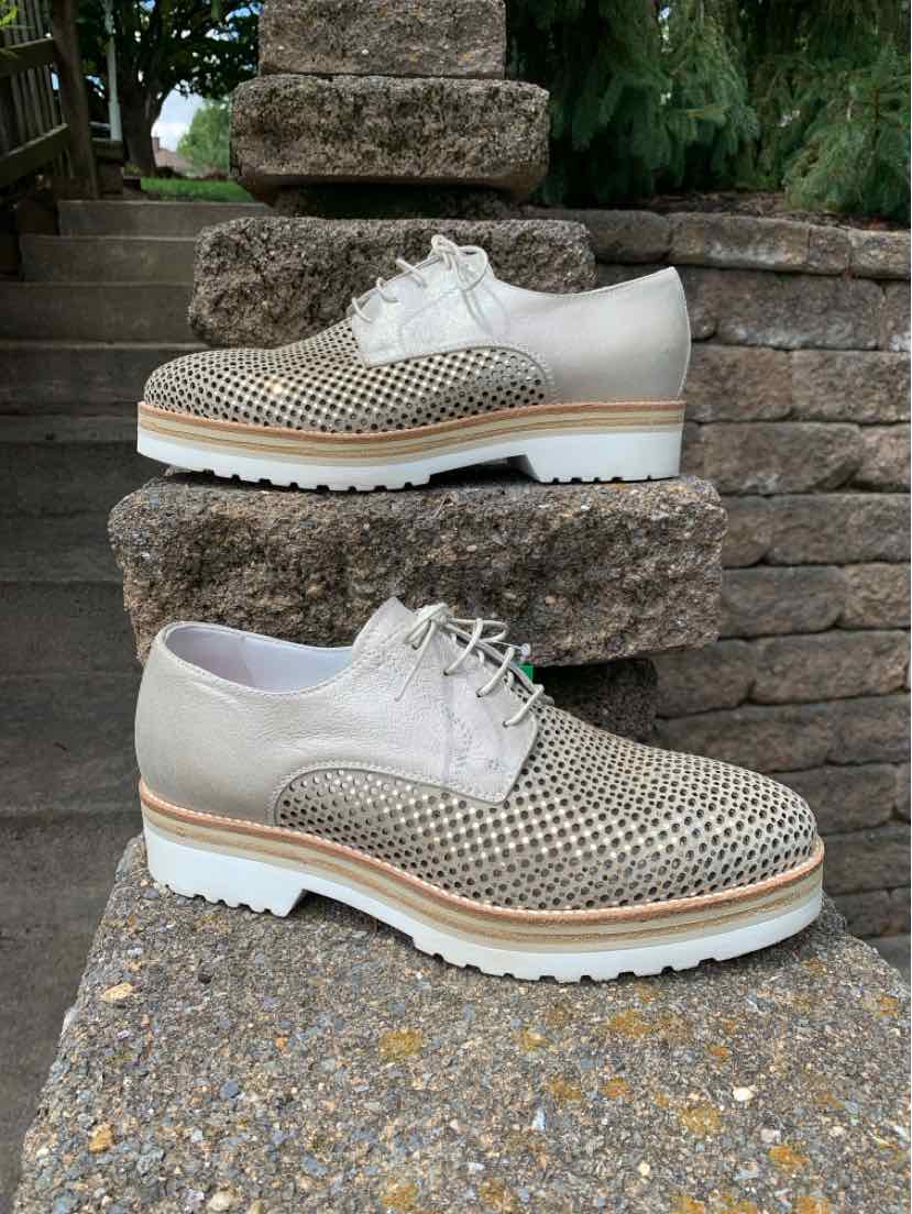 Metallic silver lace-up shoes with perforated leather upper and chunky white sole, size 40.