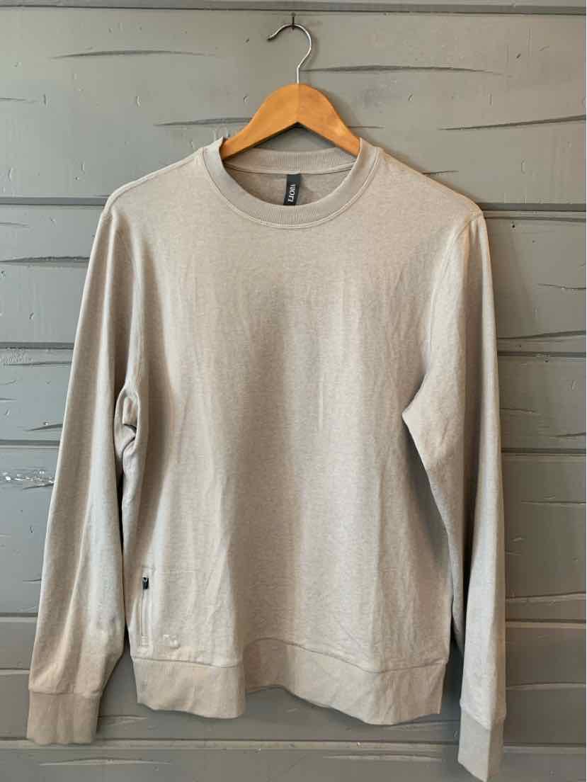 Beige long-sleeve crewneck sweatshirt with ribbed cuffs and hem on wooden hanger.