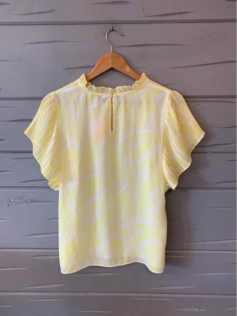 Light yellow blouse with subtle white floral print, short flutter sleeves, and a ruffled neckline with tie closure.