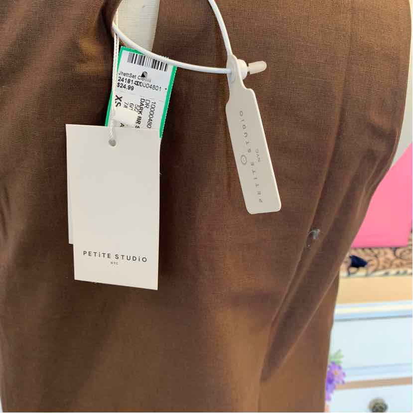 Brown fabric with PETITE STUDIO white and barcode tags attached.