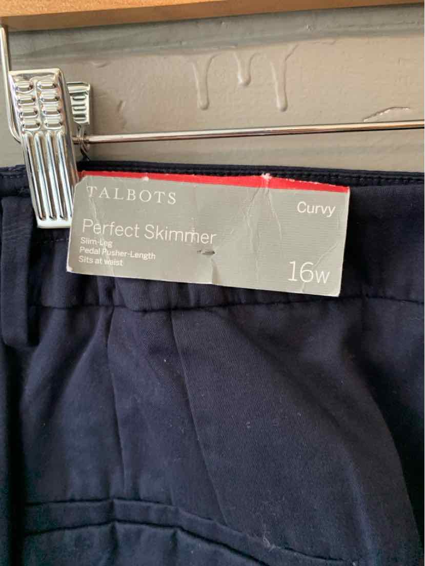 Navy blue Talbots perfect skimmers pants in size 16W with a curvy fit, hanging on clips.