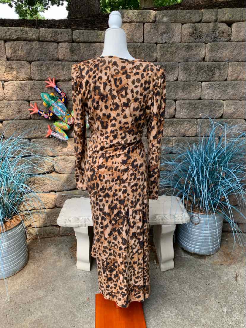Long leopard print dress with long sleeves and fitted waist on white mannequin.