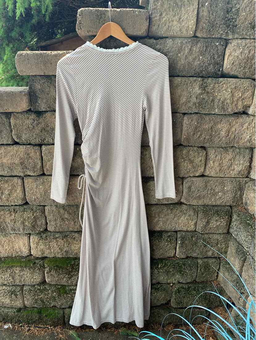 Long-sleeve mauve ribbed knit dress with side ruching and a crew neckline hanging on wooden hanger.