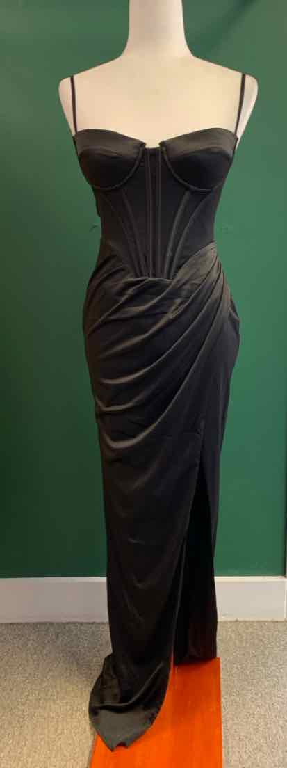 Black satin fitted dress with corset-style bodice and thin straps on mannequin.