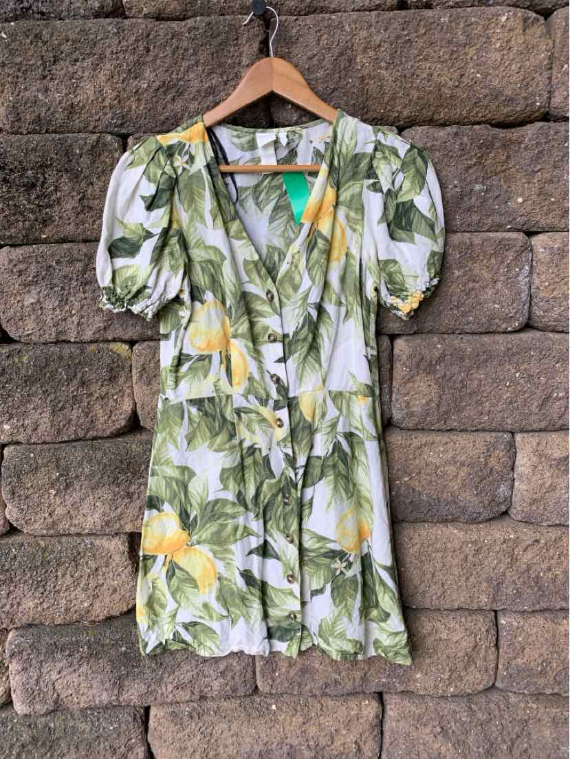 Green and lemon floral wrap dress with puff sleeves, V-neck, and waist tie in size XS.