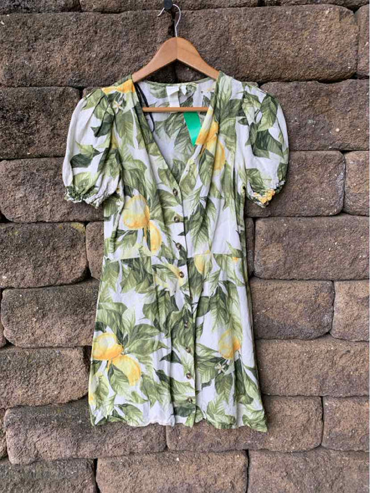 Green and lemon floral wrap dress with puff sleeves, V-neck, and waist tie in size XS.