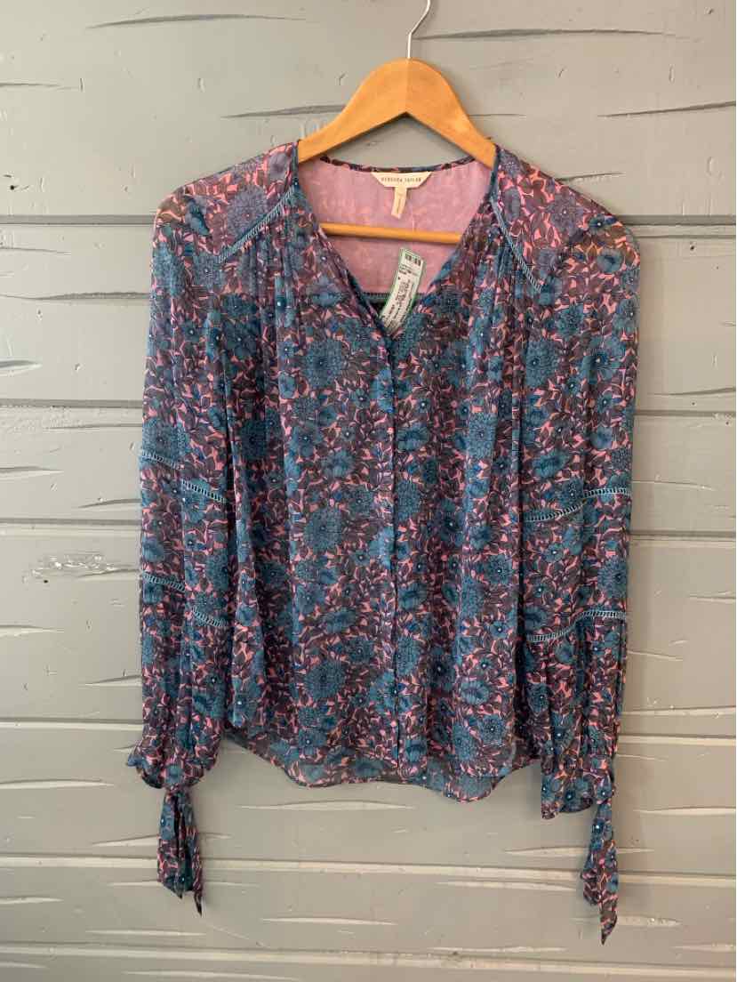 Blue floral long-sleeve blouse with button front and tie cuffs, size 4, hanging on wooden hanger.