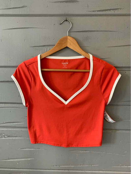 Red short-sleeve crop top with white trim along V-neck and sleeve edges, medium size.