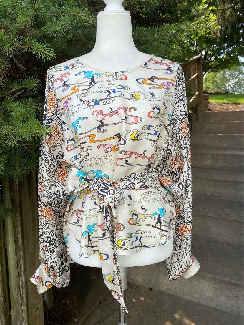 Long-sleeve multi-patterned blouse with abstract and animal print, waist tie, and lightweight fabric.