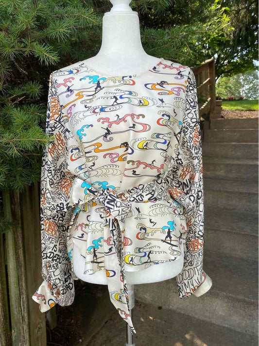 Long-sleeve multi-patterned blouse with abstract and animal print, waist tie, and lightweight fabric.