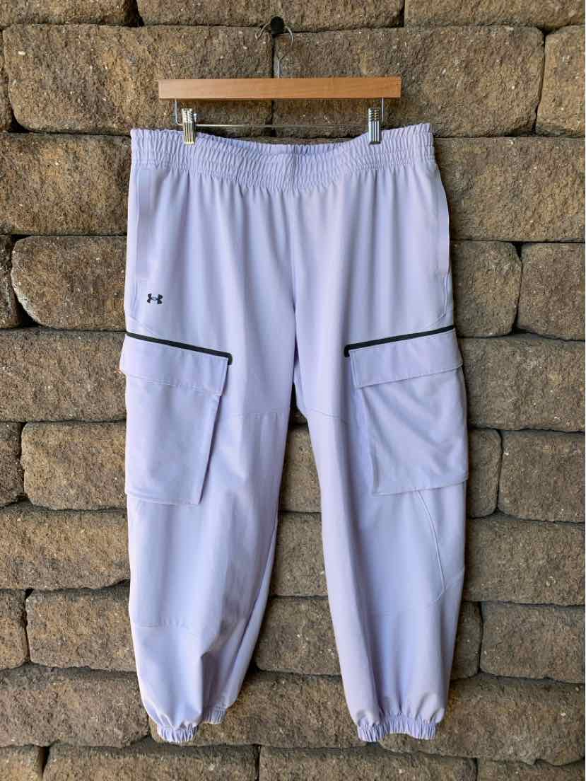 Lavender Under Armour women’s joggers with elastic cuffs, drawstring waist, and black-trimmed cargo pockets.