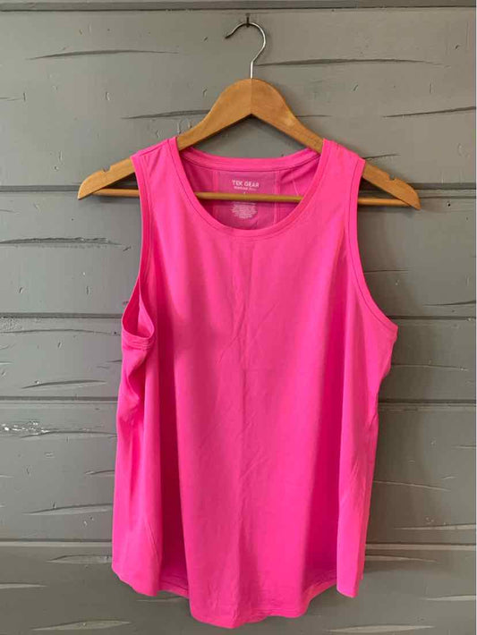 Bright pink sleeveless athletic tank top with round neckline hanging on wooden hanger.