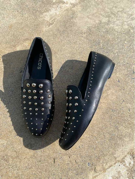 Black slip-on loafers with silver stud embellishments and rounded toes, size 7.