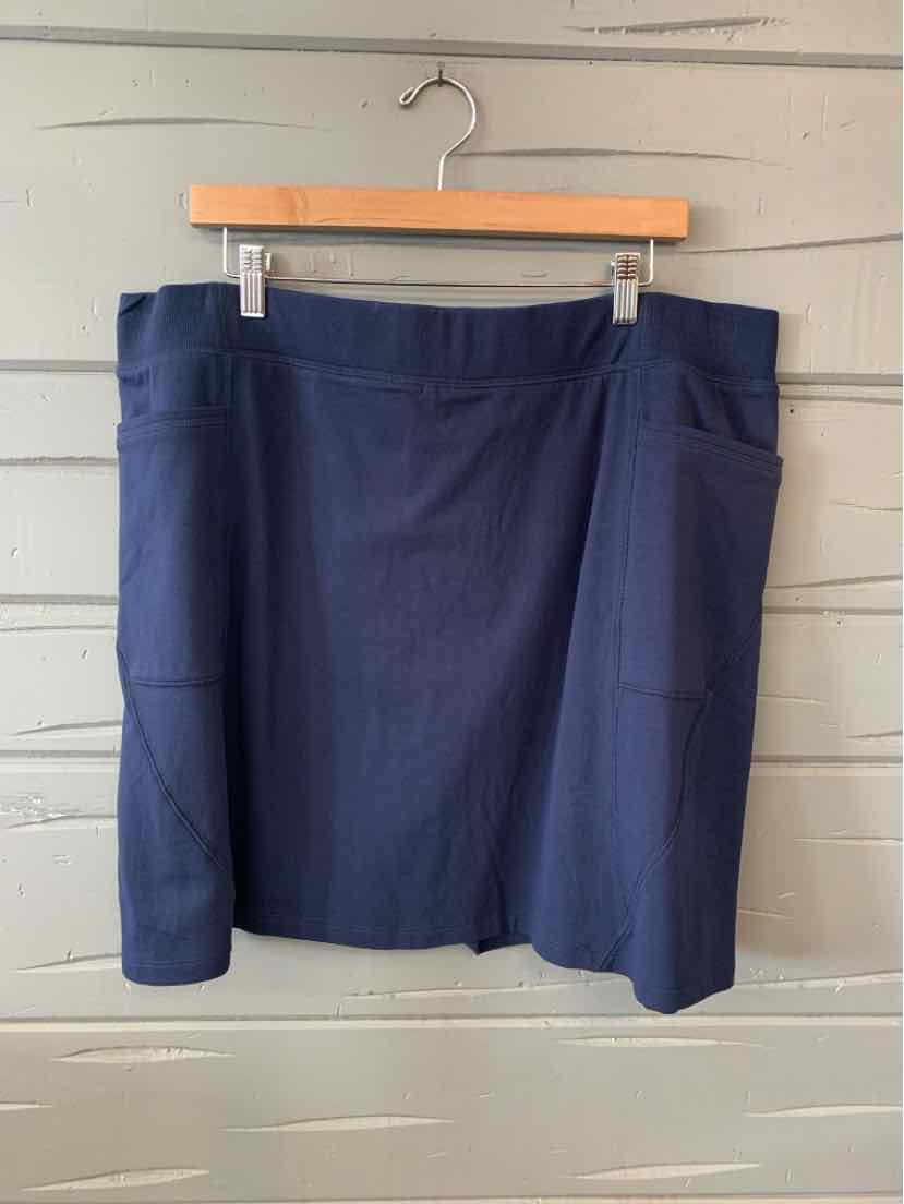 Navy blue solid skort with wide waistband and front pockets in XL size hanging on wooden hanger.
