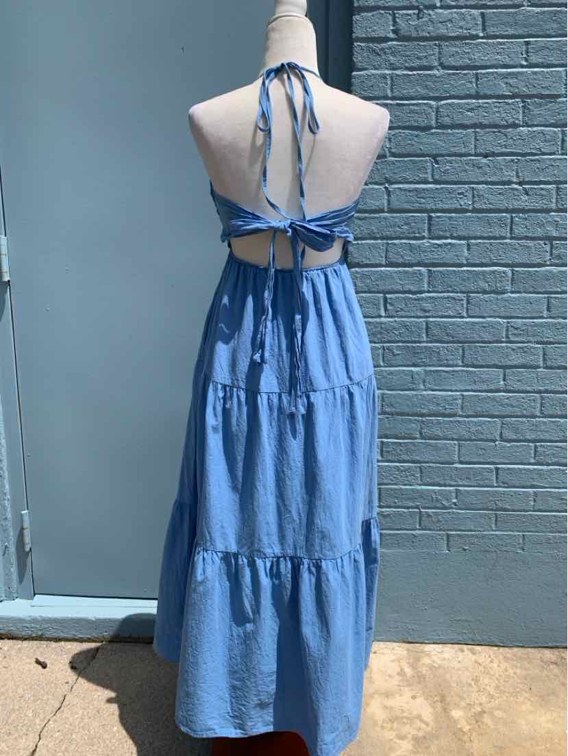 Light blue sleeveless maxi dress with tiered skirt and halter neck tie-back design.