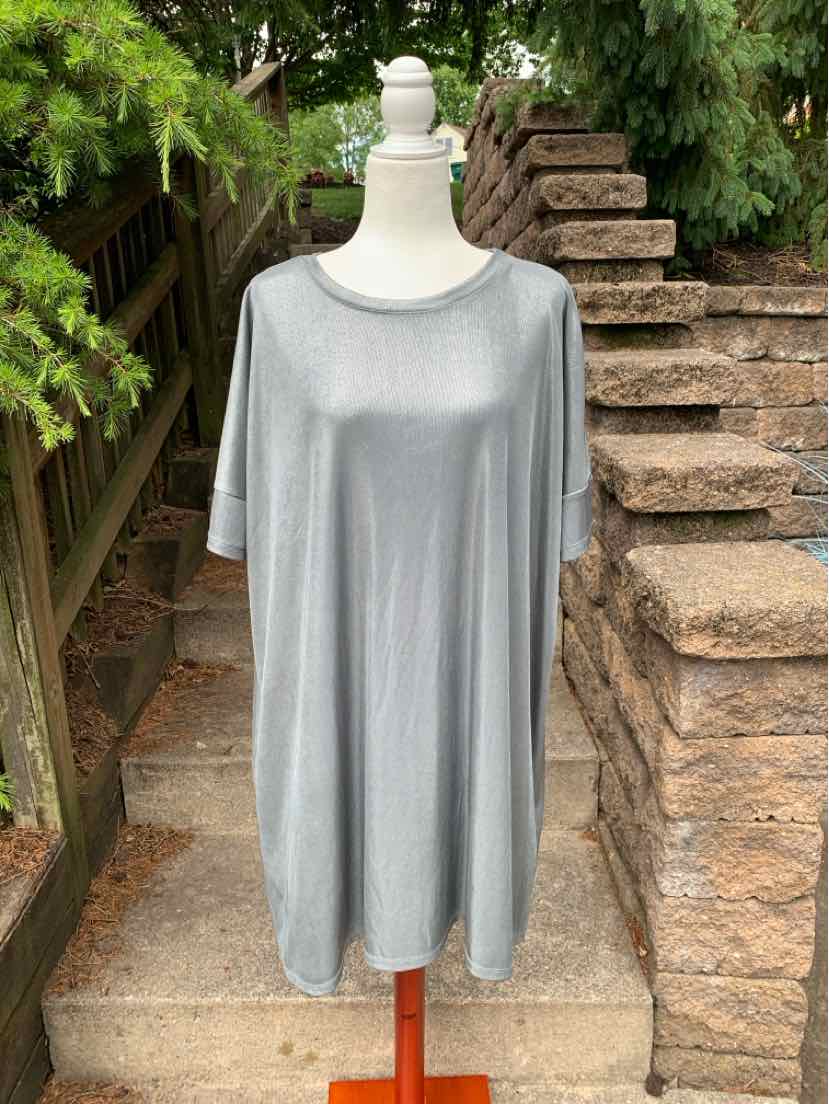 Silver metallic long-sleeve dress with loose fit and round neckline on mannequin.