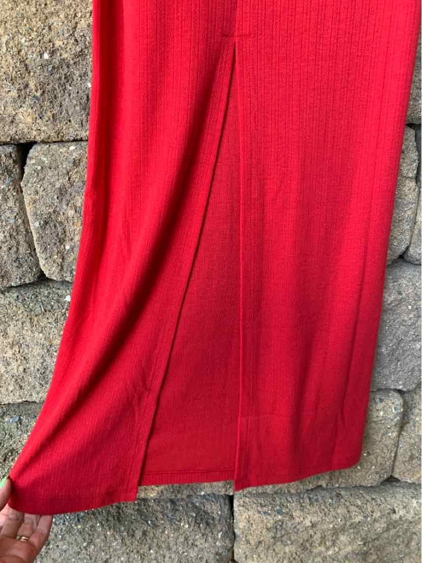 Red solid fabric dress with a straight cut and subtle slit at the hem.