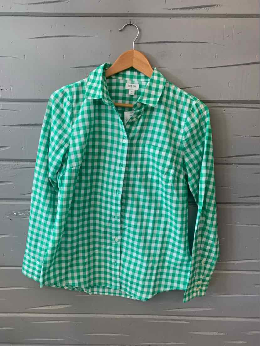 Green and white gingham button-down shirt with long sleeves on wooden hanger.