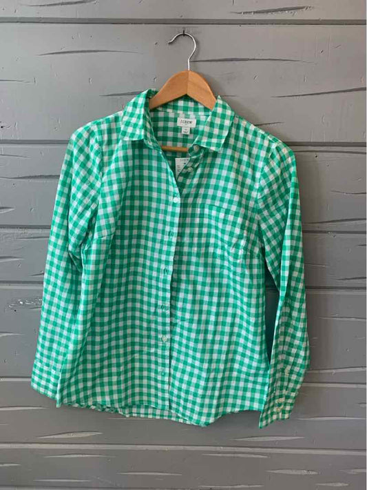 Green and white gingham button-down shirt with long sleeves on wooden hanger.
