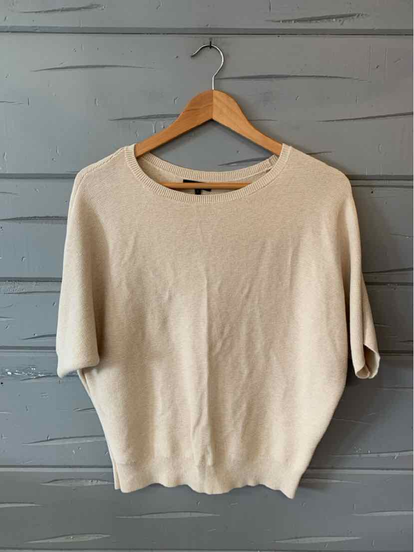 Tan short-sleeve knit sweater with crew neck and soft texture on wooden hanger.