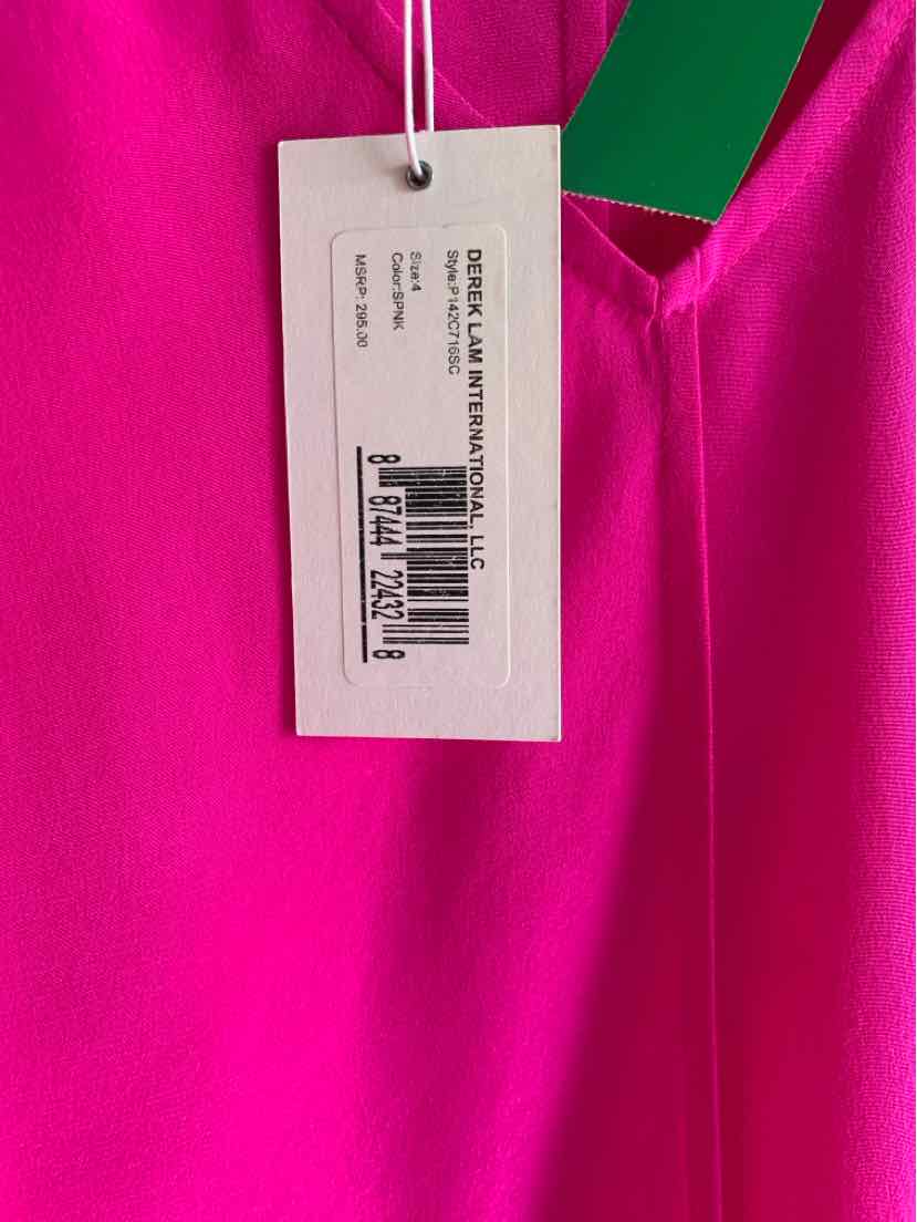 Bright pink fabric with a white Derek Lam 10 Crosby price tag attached by a string.