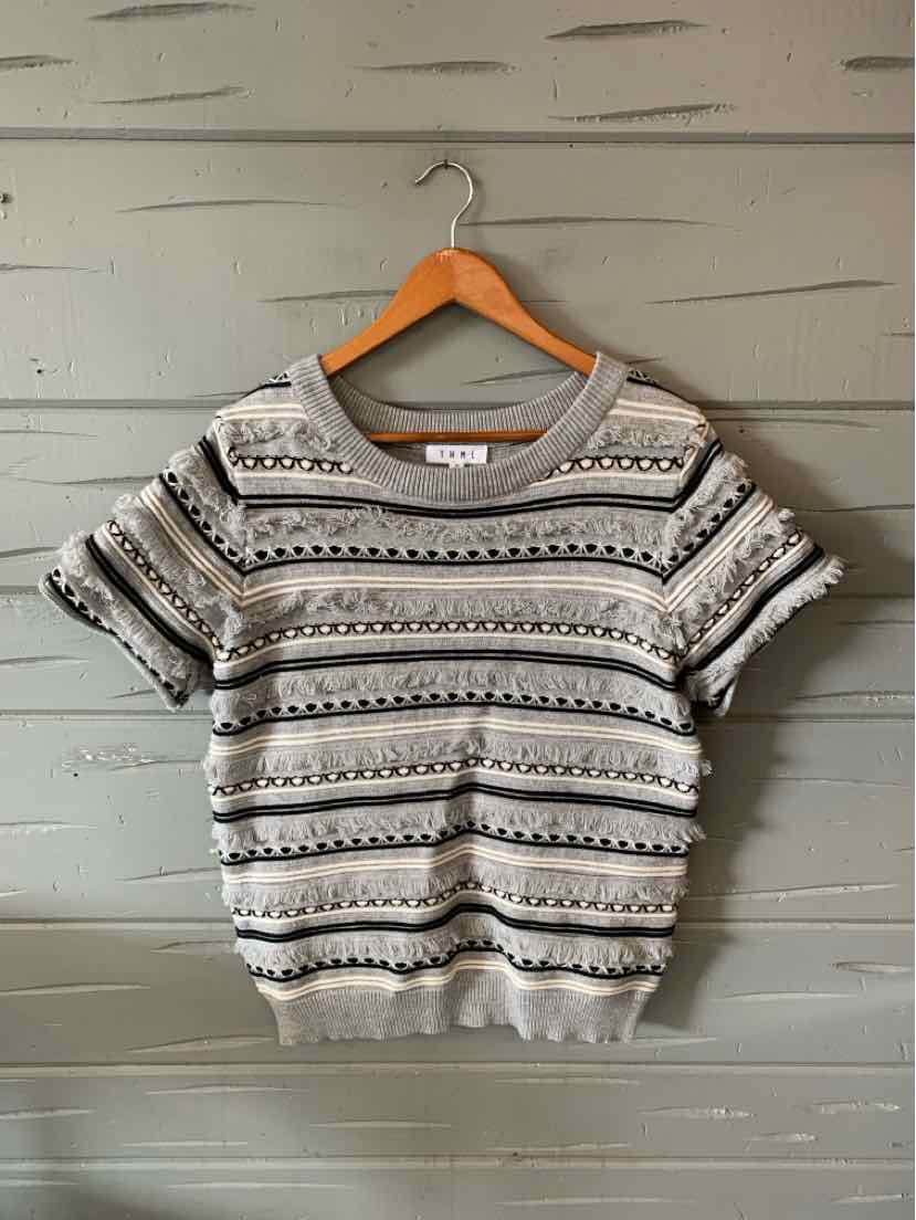 Gray short-sleeve knit sweater with horizontal black and white stripe patterns and ribbed cuffs and hem.