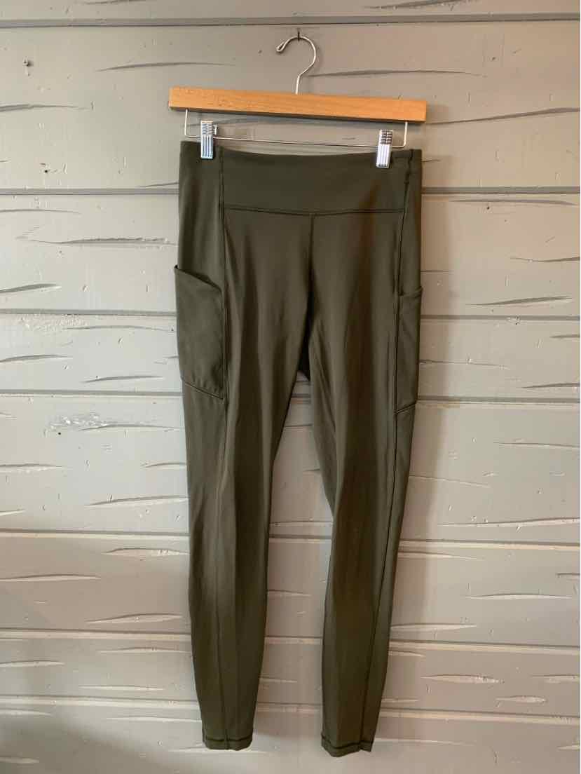 Olive green high-waisted leggings with side pocket, stretchy fabric, and slim fit.