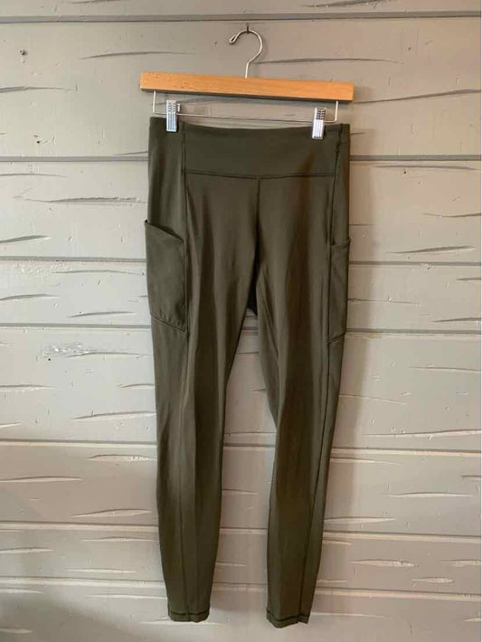 Olive green high-waisted leggings with side pocket, stretchy fabric, and slim fit.