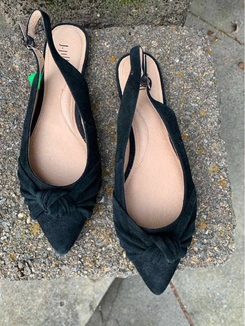 Black pointed-toe slingback flats with a knotted fabric detail on the vamp and a smooth tan insole.