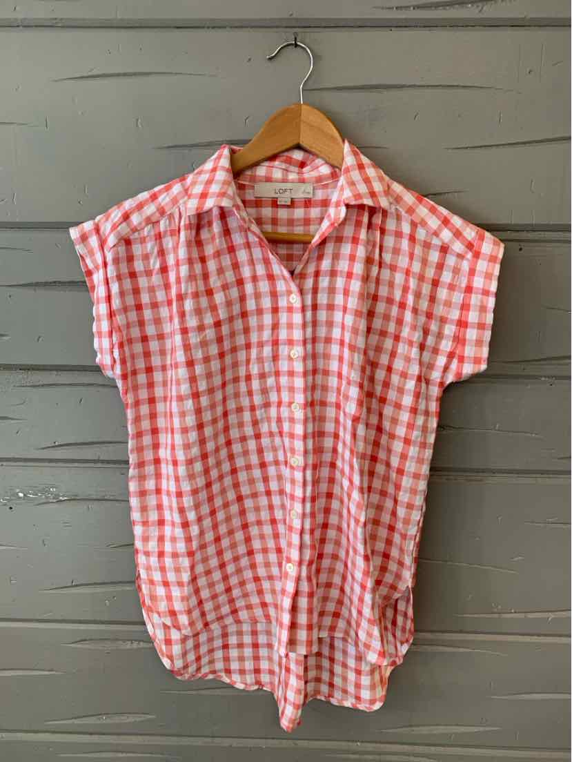 Red and white gingham short-sleeve shirt with collar and front button closure on wooden hanger.