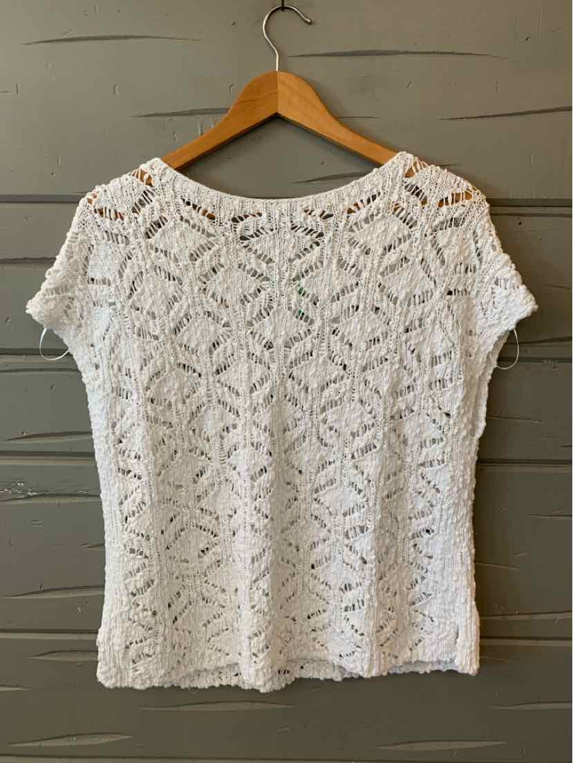 White short-sleeve knit top with openwork pattern and round neckline on wooden hanger.