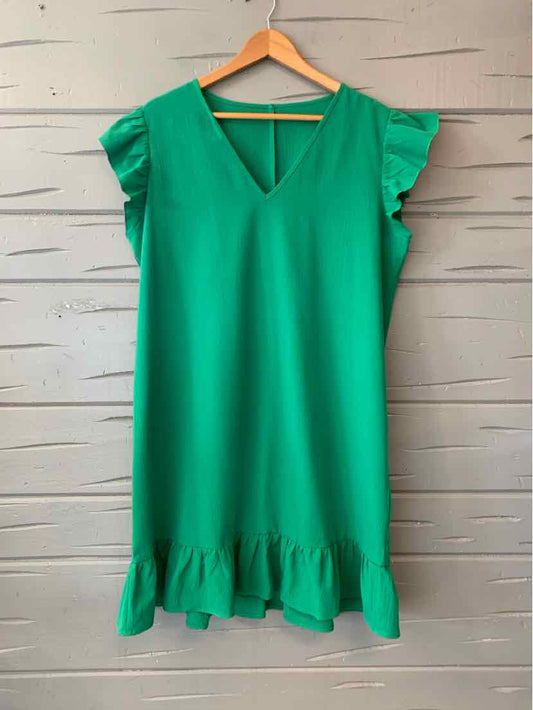 Green sleeveless dress with V-neck, ruffled shoulders, and a ruffled hem.