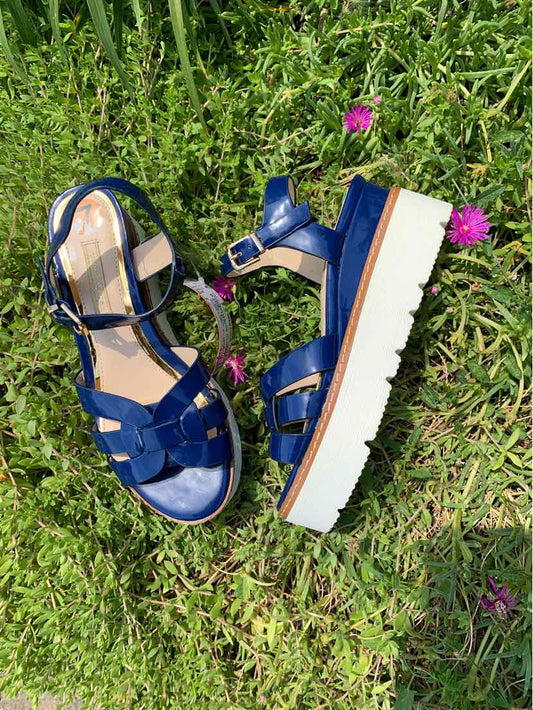 Blue leather women's sandal with multiple straps, buckle closure, and thick white platform sole.