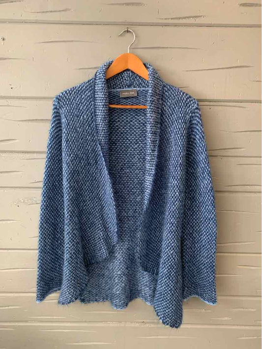 Soft blue textured knit cardigan with shawl collar and long sleeves on wooden hanger.