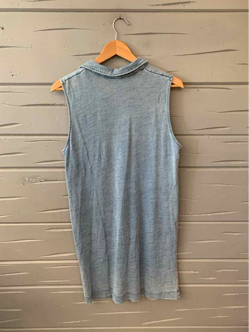 Sleeveless light blue knit dress with mock neck, mid-length, on wooden hanger against textured wall.