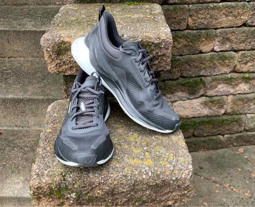 Black Lululemon women's sneakers with white soles, mesh and synthetic upper, lace-up design, size 9.