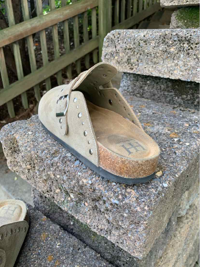 Beige leather peep-toe wedge sandal with a perforated ankle strap and cork-textured sole.