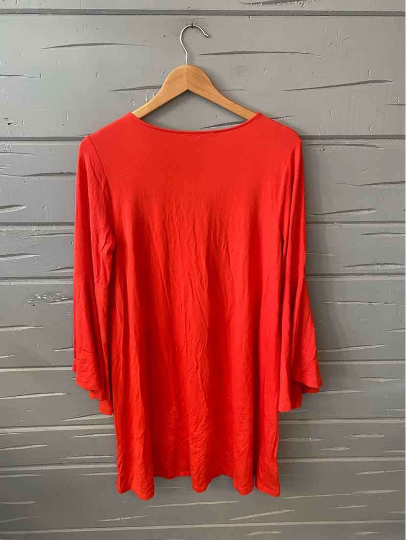 Bright red, loose-fit women's top with three-quarter sleeves on a wooden hanger against a gray textured background.