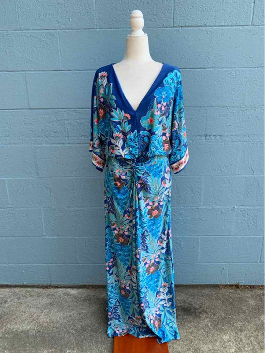 Blue floral wrap dress with V-neck, elbow-length sleeves, and tie waist detail.