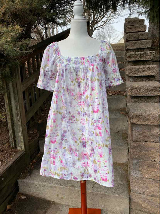 White floral smock dress with pink and purple blossoms, puffed short sleeves, square neckline.