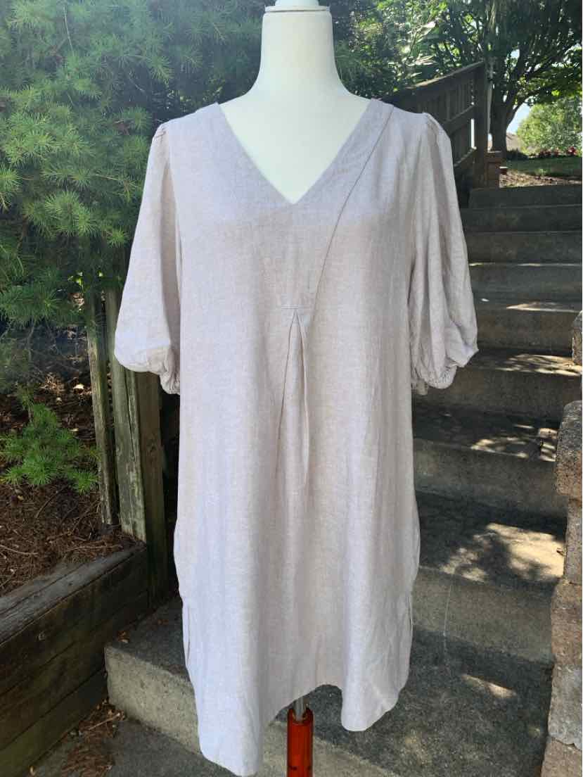 Beige linen dress with V-neck and elbow-length sleeves, loose fit, knee-length hem.