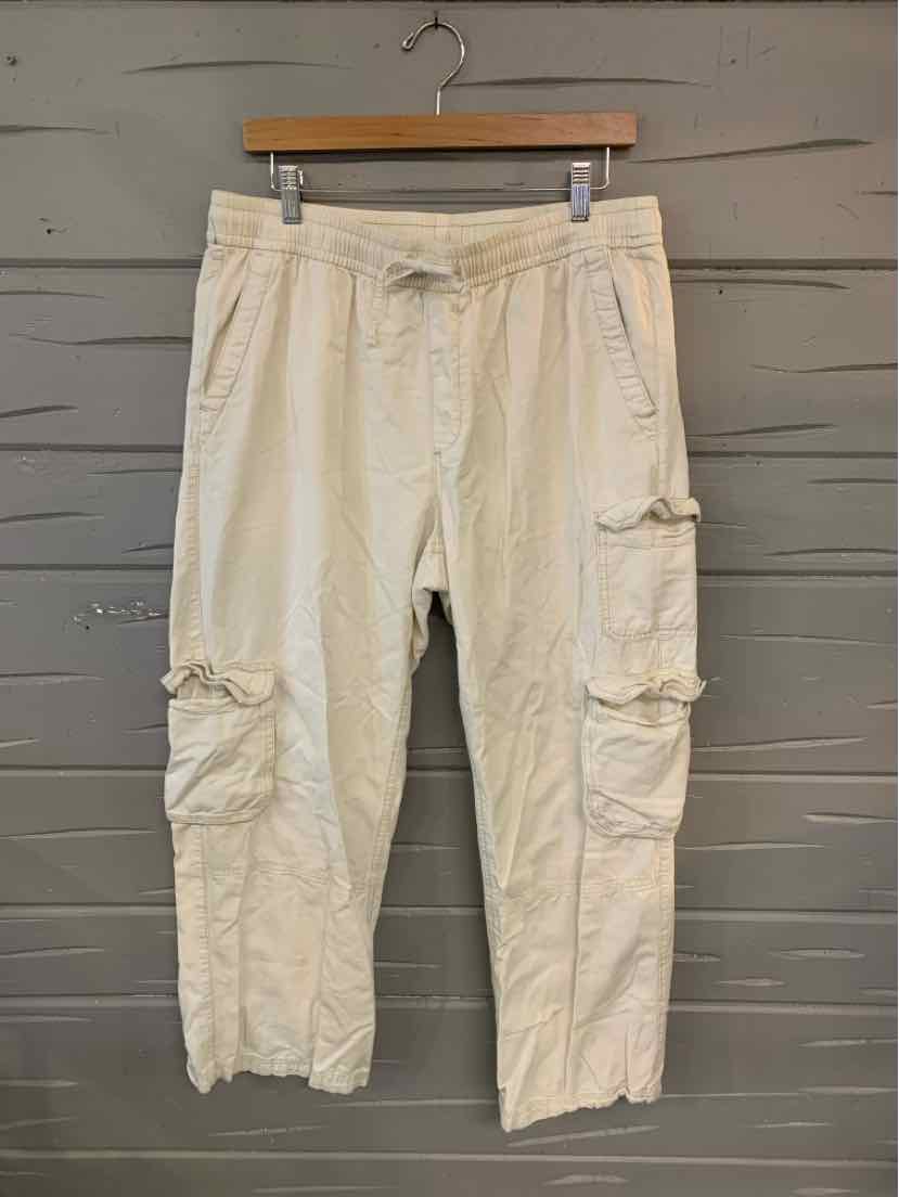 Light beige cargo pants with multiple pockets and button details, size large.