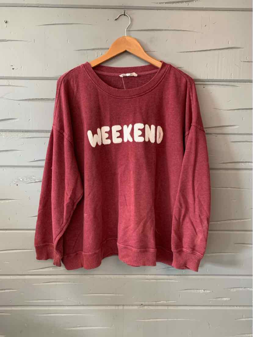 Burgundy oversized sweatshirt with white "WEEKEND" graphic across the chest, crew neckline, and long sleeves.