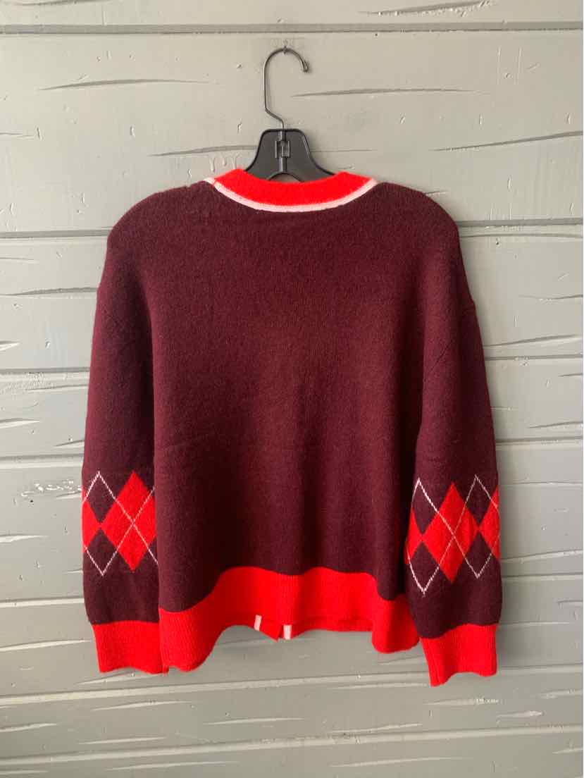 Burgundy sweater with red and pink argyle pattern on sleeves and bright red cuffs and collar.